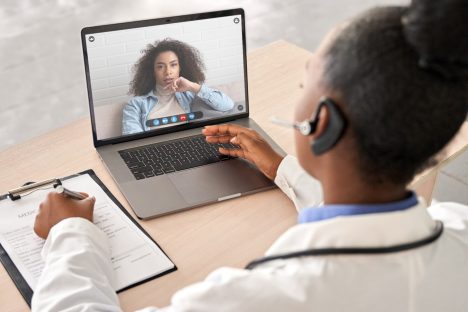 doctor talk to patient by online webcam video call on laptop screen