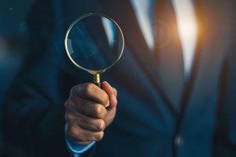 person holding magnifying glass